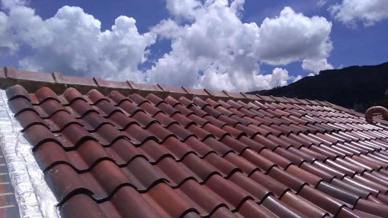 Cubierta en teja de barro restaurada bajo cielo despejado